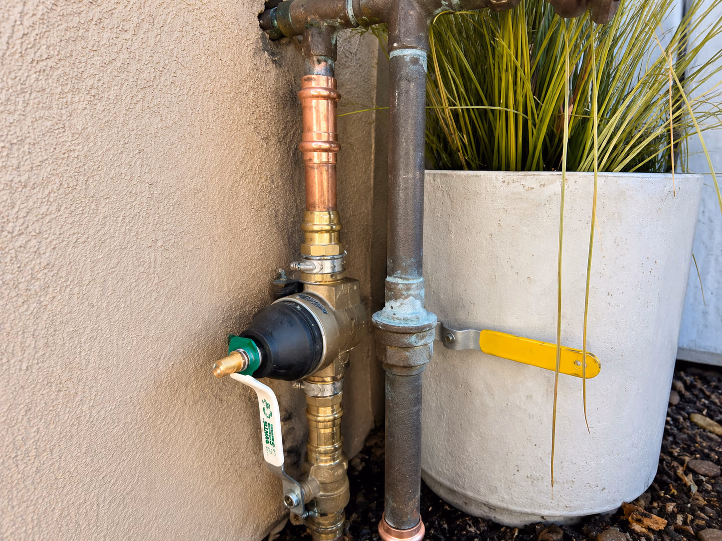 New brass pressure reducing valve installed on a residential copper main water line, calibrated for 50 to 70 PSI
